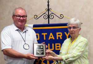 Greg Stidham receives plaque of appreciation